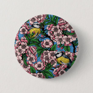 Blauzungenvögel im blühenden Kirschbaum auf blau Button