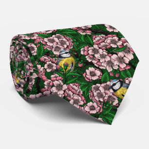 Blauzungenvögel im blühenden Kirschbaum auf Gras Krawatte