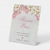 Blumenbar mit rosa Schrift und Orchideen auf Marmo Sockelschild (Vorderseite)