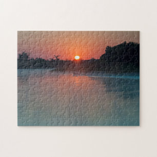 Boot bei Sonnenaufgang auf dem Fluss Puzzle