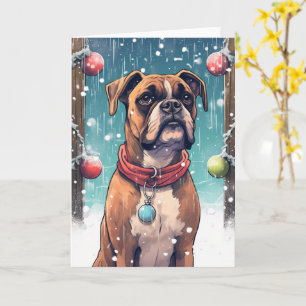 Boxer spielt mit Weihnachtsdekoration im Schnee Karte