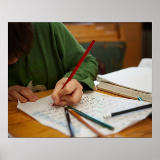 Boy concentrating on math homework poster