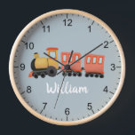 Boys Niedlich Blue Modern Travel Travel Baby Kinde Uhr<br><div class="desc">Diese niedliche und moderne Baby-Kinderzimmer-Uhr verfügt über eine Tourenansicht und einen Platz, in dem Sie den Namen Ihres Jungen hinzufügen können. Ideal für Kinder, die von einem Zugfahrer oder einem neuen Baby träumen! Mit klaren Zahlen und einem blauen Hintergrund ist diese Uhr auch ideal für Kleinkinder, die lernen, die Zeit...</div>