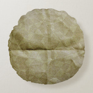 Braunes Papier knittern. Das Papier falten. Hinter Rundes Kissen