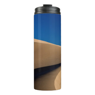 BRENNSAND UNTER BLAUEM HIMMEL WÄHREND DES TAGES THERMOSBECHER