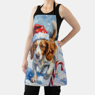 Bretonischer Spaniel Hund zeigt auf Weihnachtsbonb Schürze