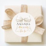 Bride to be ivory bow pearls elegant Bachelorette Runder Aufkleber<br><div class="desc">Celebrate in style with this elegant bachelorette party wine glass. The design features a delicate ivory,  cream colored bow accented with pearls and sophisticated gold-toned typography. It makes a perfect commemorative gift for the bride-to-be to use during her bridal shower or girls' night out.</div>