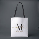 Bridesmaid Gift Gold Black Monogram White Tasche<br><div class="desc">Diese Bridesmaid Tote-Tasche enthält ein handgeschriebenes Monogramm aus Gold und schwarzem Schrift mit Swashes auf weißem Hintergrund. Präsentieren Sie Ihre Brautjungfrauen mit einer Tasche für die Beförderung von Gegenständen am Tag der Hochzeit,  und traditionell am Probe-Dinner oder vorher präsentiert.</div>