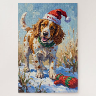 Brittany Spaniel zeigt auf Santa's Handschuhhut Puzzle