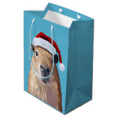 Capybara feierlich in Weihnachtsmannmütze Mittlere Geschenktüte (Rückseite Schrägansicht)