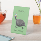 Cartoon-Illustration von guineischen Vögeln Sockelschild (In SItu)