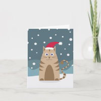 Cartoon Katze mit Weihnachtsmannmütze im Schnee