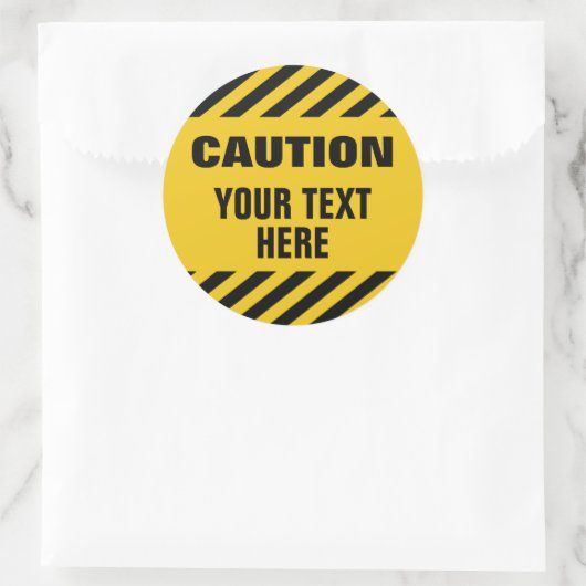Caution stripes with any text round runder aufkleber (Tasche)