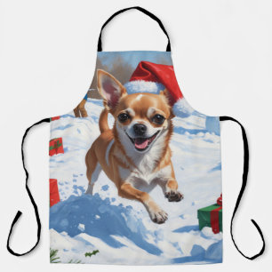 Chihuahua läuft in Schnee mit Weihnachtshut Schürze
