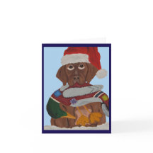 Chocolate-Labrador-Welpe mit Santa-Hut und Enten-S