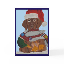 Chocolate-Labrador-Welpe mit Santa-Hut und Enten-S