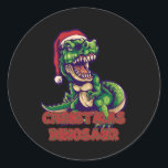 Christmas Green Dinosaurier | Dinosaurier-Design Runder Aufkleber<br><div class="desc">Wärmen Sie mit einem heißen Getränk auf und setzen Sie eines unserer Weihnachtsdinosaurier-Designs auf,  um Ihr Lieblingsmämmer aus Ihrer Jugend zu zeigen. Die Freuden der Welt sind deine!</div>