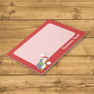 Christmas penguin getting a snow ball notizblock