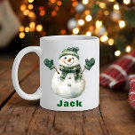 Christmas Snowman Green Scarf Individuelle Name Kaffeetasse<br><div class="desc">Erleben Sie den Urlaubssinn mit einer Weihnachts-Snowman Green Hat Individuelle Name Kaffeemaschine Tasse! Diese bezaubernde Weihnachtskaffee-Tasse besticht durch einen klassischen, fröhlichen Schneemann, der mit einem gemütlichen grünen Strickhut, passenden Milben und einem karierten Schal geschmückt ist. Einfach mit jedem Namen anpassen, um es zu einem bezaubernden Urlaubsparnis, Wintergeschenk oder einer einzigartigen...</div>