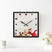 Christmas Themed Items on a Rustic Wooden Board Quadratische Wanduhr (Zuhause)