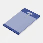 Chrom mag Caduceus-medizinisches Symbol auf blauem Post-it Klebezettel (angewinkelt)