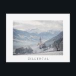 Church in Zillertal in winter white text postcard Postkarte<br><div class="desc">Postcard of the church of St. Pankraz in an alpine landscape in the snow surrounded by clouds and fog on a hill with a view over Zillertal valley with the Alps mountains in the background in Fügen,  Austria in winter with a white border and the text: 'Zillertal'.</div>