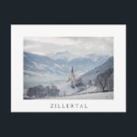 Church in Zillertal in winter white text postcard Postkarte<br><div class="desc">Postcard of the church of St. Pankraz in an alpine landscape in the snow surrounded by clouds and fog on a hill with a view over Zillertal valley with the Alps mountains in the background in Fügen,  Austria in winter with a white border and the text: 'Zillertal'.</div>