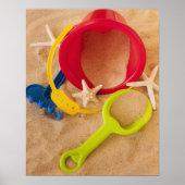 Close up of toys on sand poster (Vorne)