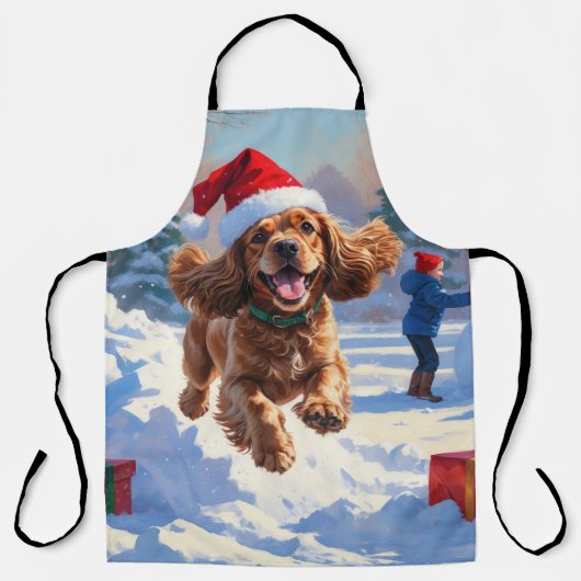 Cocker Spaniel läuft im Schnee mit Weihnachtsmütze Schürze (Vorderseite)