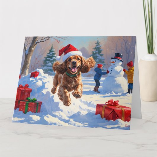 Cocker Spaniel läuft in Schnee mit Weihnachtshut Karte (Vorderseite)