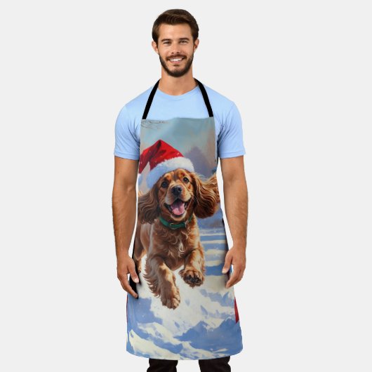 Cocker Spaniel läuft in Schnee mit Weihnachtshut Schürze (Getragen)