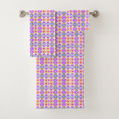 Colorful geometric-patterned towels on a rack badhandtuch set (Insitu)