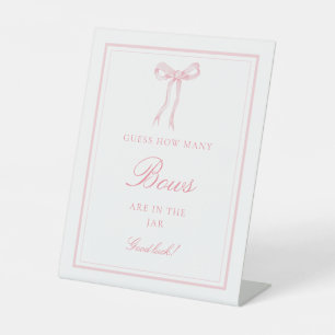 Coquette Pink Guess Wie viele Bows Game Sign Sockelschild