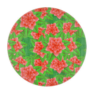 Coral Orange Camellias und grüne Blätter Schneidebrett