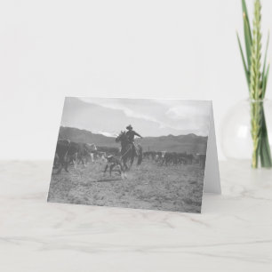 Cowboy roping a calf for spring branding. karte