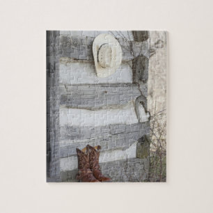 Cowboystiefel und Hut außerhalb der Blockhütte Puzzle