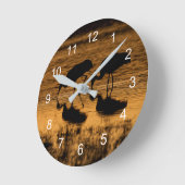 Cranes Silhouette vom Sonnenuntergang Runde Wanduhr (Winkel)