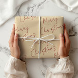 Cream and Red Merry Christmas Geschenkpapier<br><div class="desc">Traditionelles,  schlicht gefärbtes Packpapier. Moderne Creme mit frohen Weihnachten in rot handgeschriebenem Schriftart,  gedruckt in einem sich wiederholenden Muster. Cream und Red Merry Weihnachtswrapping Papier. Cremefarbe #FDE8C7. Carmine Red #8D011F.</div>