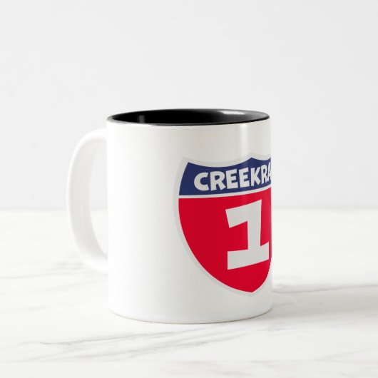 Creekrat Cartoon Studios Nummer eins Zweifarbige Tasse (Vorderseite Links)