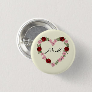 Crèmefarbenes Abzeichen mit einem rosa und roten H Button