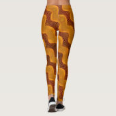 Curva laranja e pontos dourados sobre fundo marrom leggings (Rückseite)