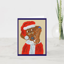 Dachshund-Welpe erzählt dem Weihnachtsmann seine W Einladung