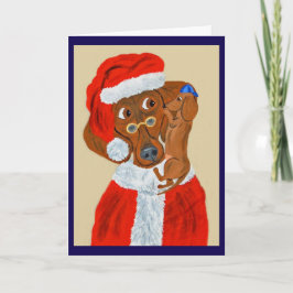 Dachshund-Welpe erzählt dem Weihnachtsmann seine W Karte