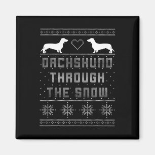 Dackel durch den schneebedeckten Weihnachtssüßer Magnet