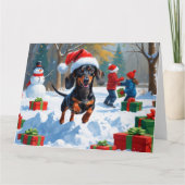 Dackel läuft im Schnee mit Weihnachtshut Karte (Vorderseite)