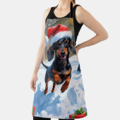 Dackel läuft im Schnee mit Weihnachtshut Schürze (InSitu)