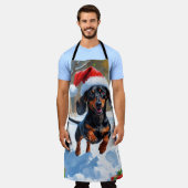 Dackel läuft im Schnee mit Weihnachtshut Schürze (Getragen)