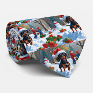 Dackel läuft im Schnee mit Weihnachtsmütze Krawatte