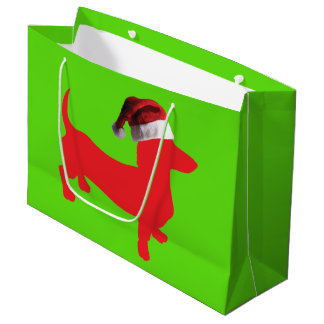Dackel mit einer Weihnachtsmannmütze zu Weihnachte Große Geschenktüte