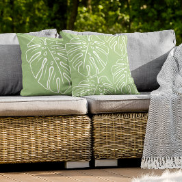 Das Motiv aus weißem tropischem Leaf auf hellgrün Kissen